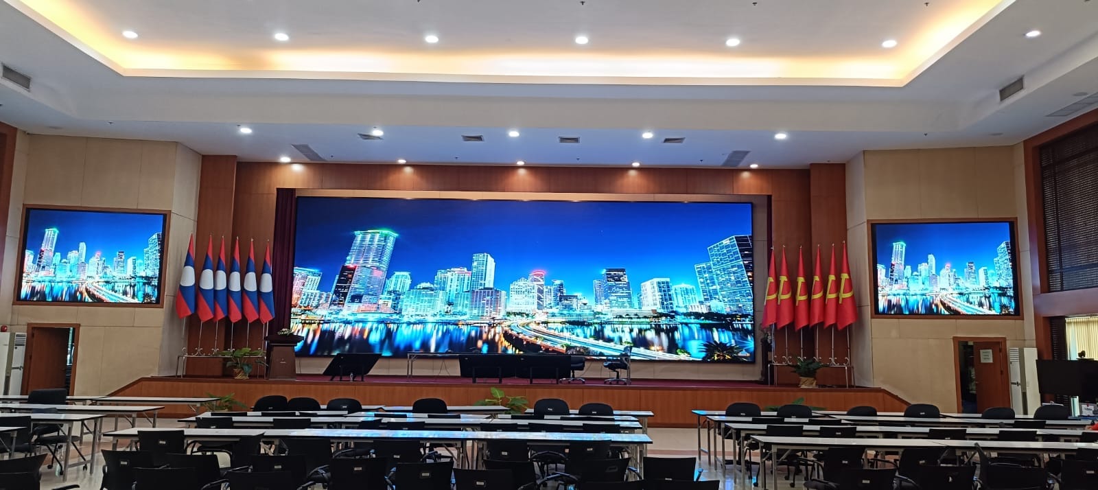 Main hall LED wall with flanking displays — Centre wall plus two side screens, installed for a conference hall in Vientiane.