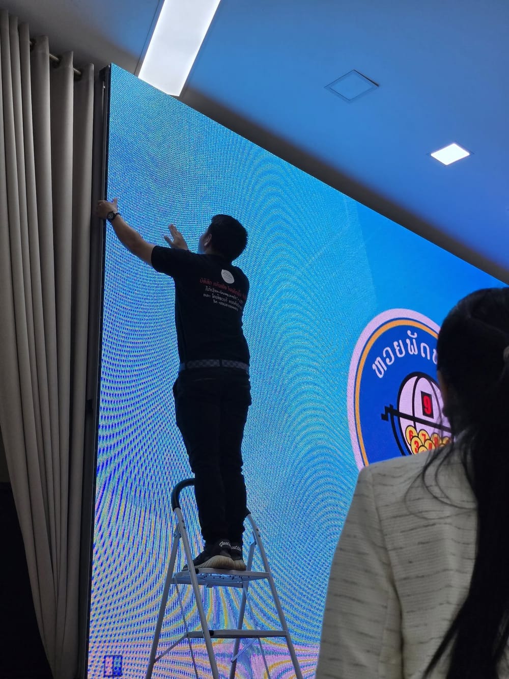 Panel alignment during commissioning — Our engineer aligning modules on an installed indoor wall before handover.