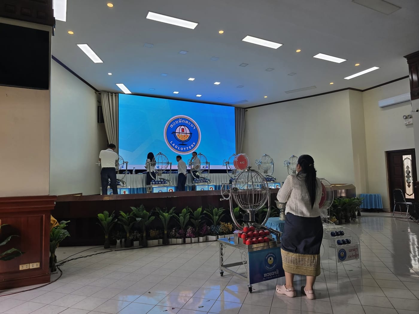 Broadcast draw hall — Stage LED wall and side monitors for a live televised draw, Vientiane.